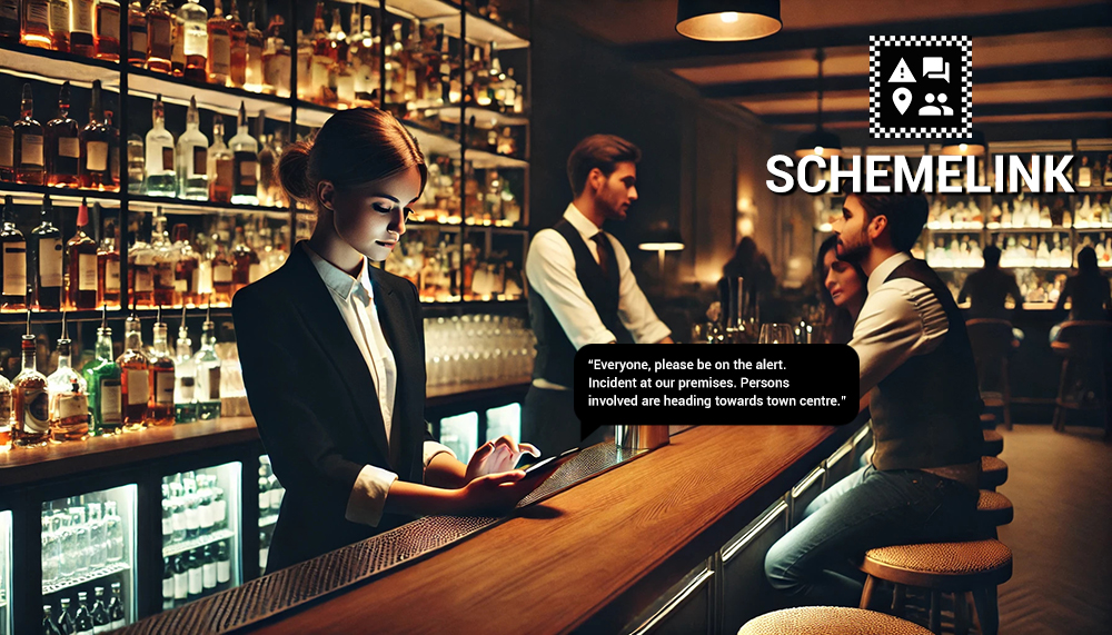 Schemelink app being used by a female member of bar staff behind the bar sending an alert about an incident